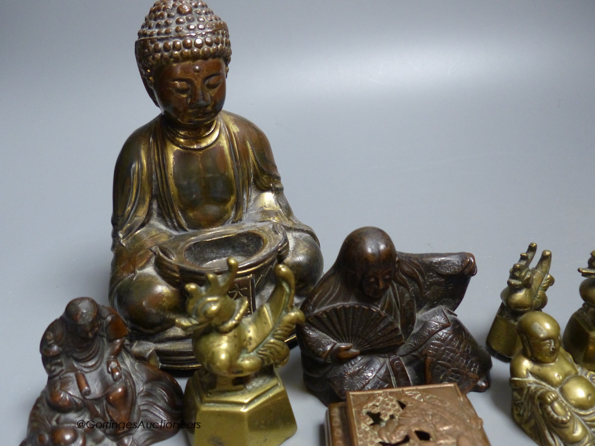 A group of mixed Oriental Buddha's, vases, weights, etc.